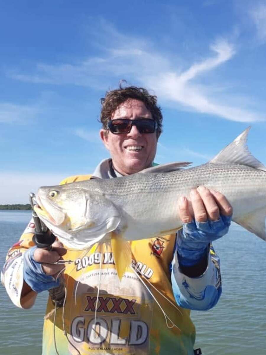 Rob, the Fishseeker owner-operator, holding a threadfin salmon on the water